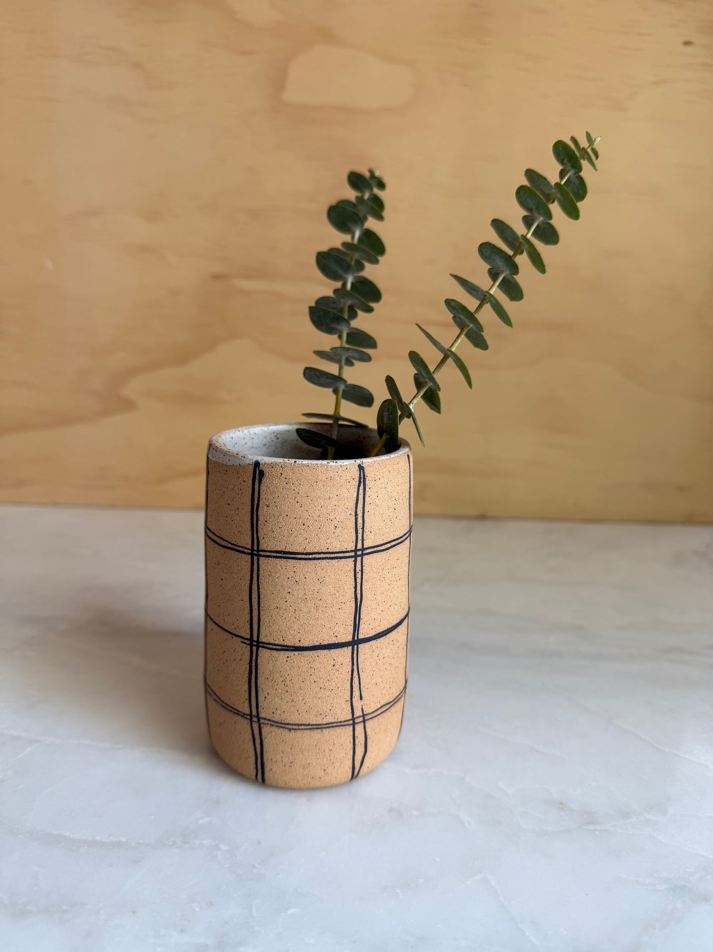 Ceramic cylinder vase with hand painted plaid design