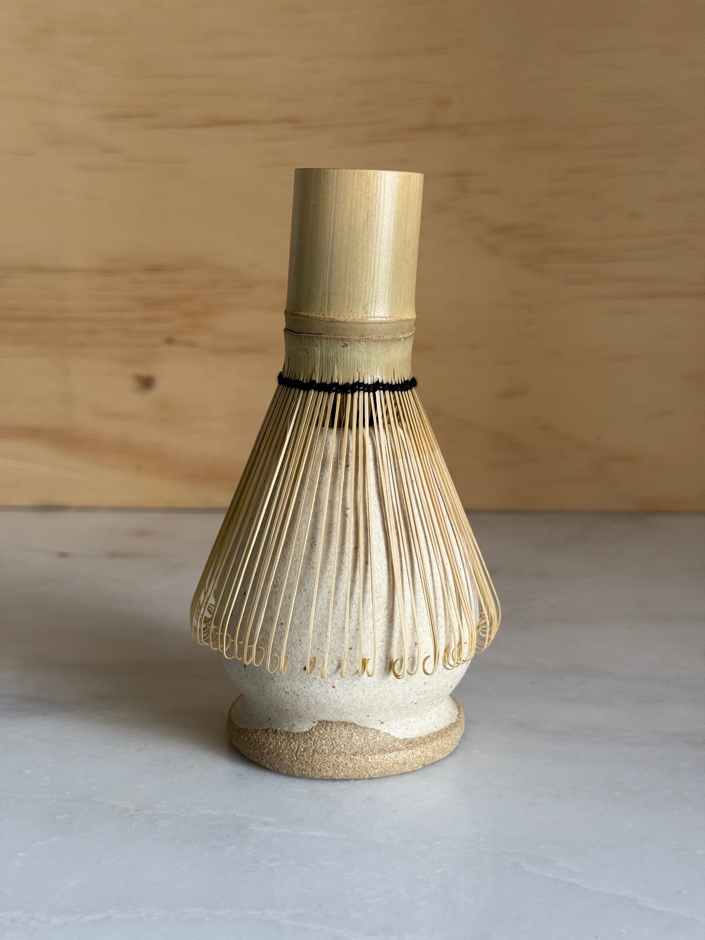Macha whisk holder holding a Matcha whisk